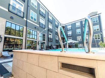 a swimming pool with a fountain in front of an apartment building at The Foundry, Indiana